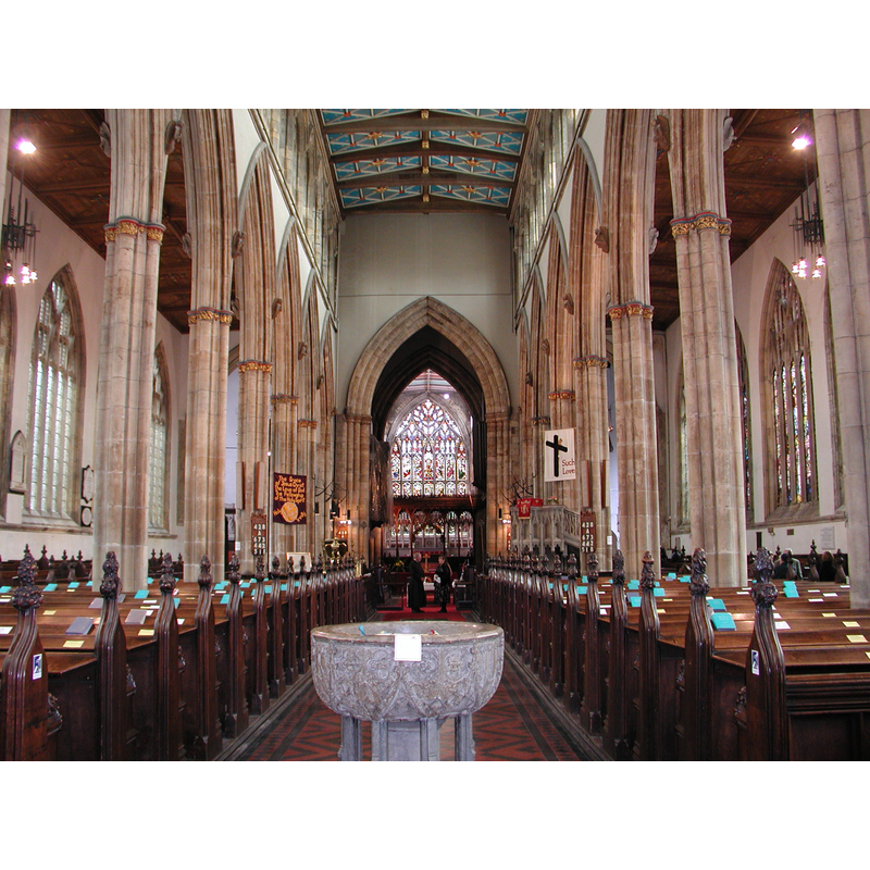 view of church interior from the west end of the nave with the font in the forefront