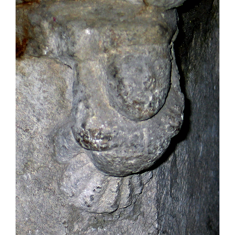 on the upper part of the base, corresponding to a human bust on the underbowl