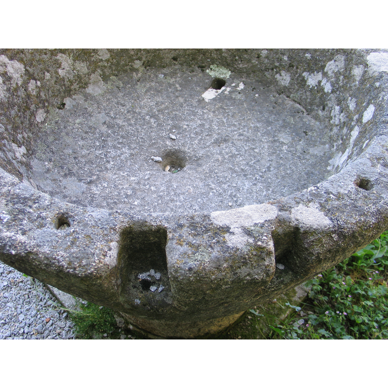 notice the indented cuts and the drilled holes in the upper rim