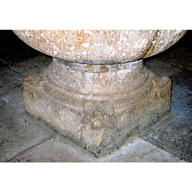 one at each angle of the upper corner of the lower volume of the base