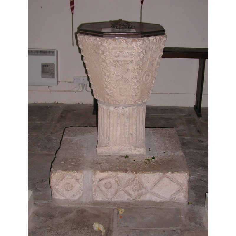 a square pattern on one side of the plinth -- on the other, some of the rhomboid shapes have circles in them