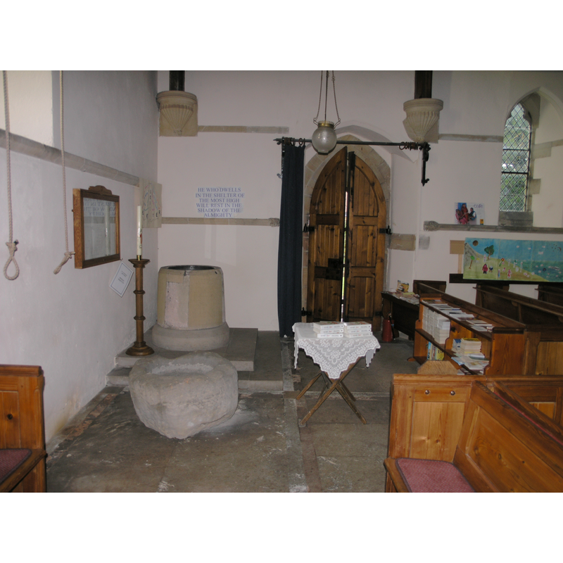 the Norman font in the background, W of the N entrance