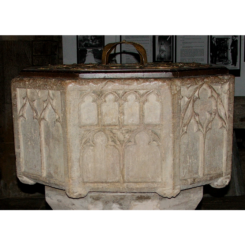 at the bottom end of each angle of the octagonal basin [could be heads or masks]