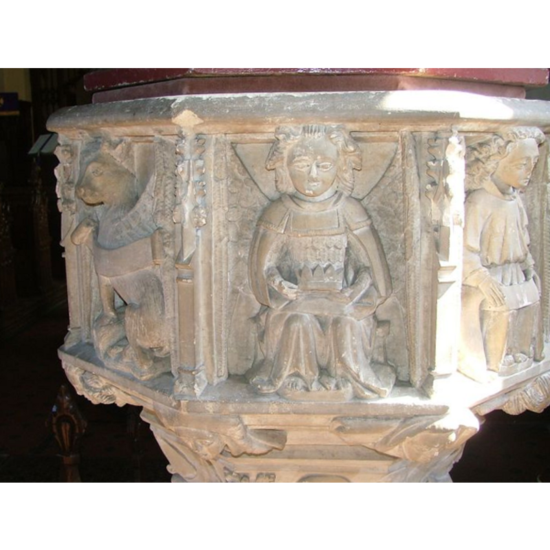 an angel (?) holding a crown, flanked by the symbols of two of the Evangelists