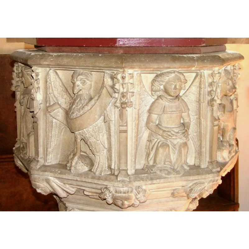 symbol of John the Evangelist on the left; angel (?) holding an object in its lap