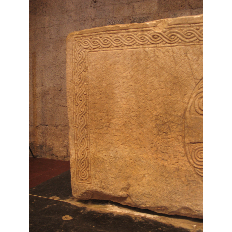 on three sides, forming a frame for the inner ornamentation