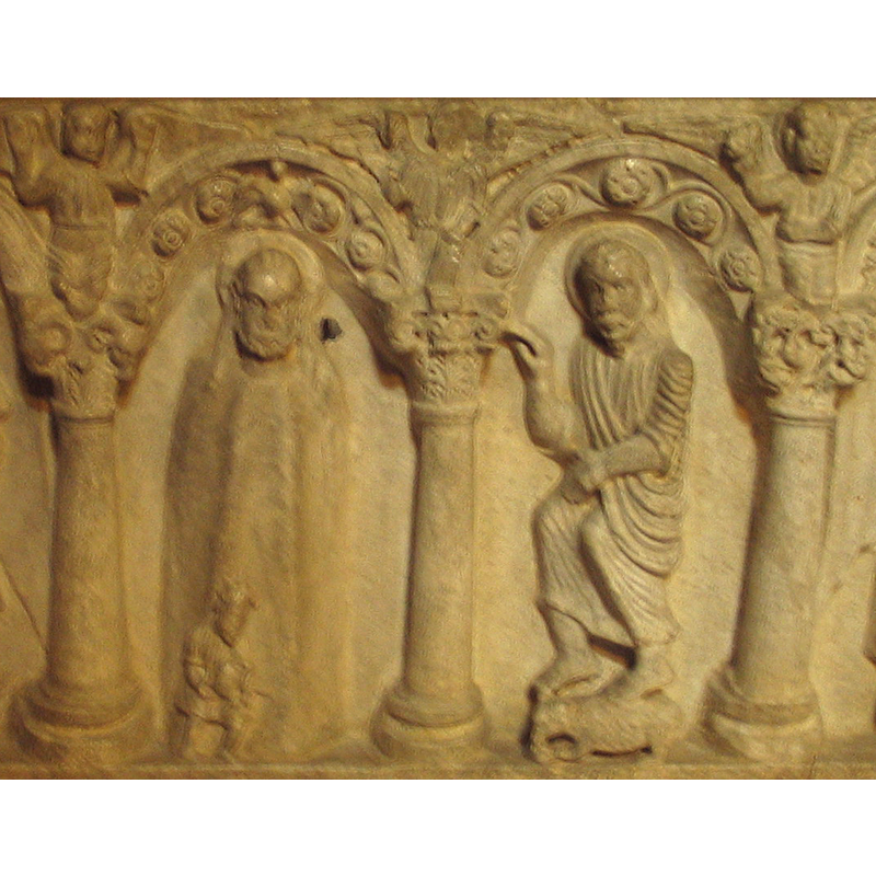 centre arch: Simplified figure of Christ in a hieratic posture; at the bottom, a human figure empties fluid from a container, a symbol of the rive Jordan