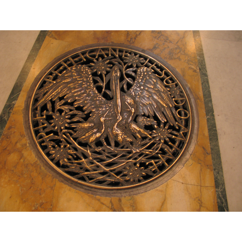 one of the brass plates decorated with baptismal symbols
