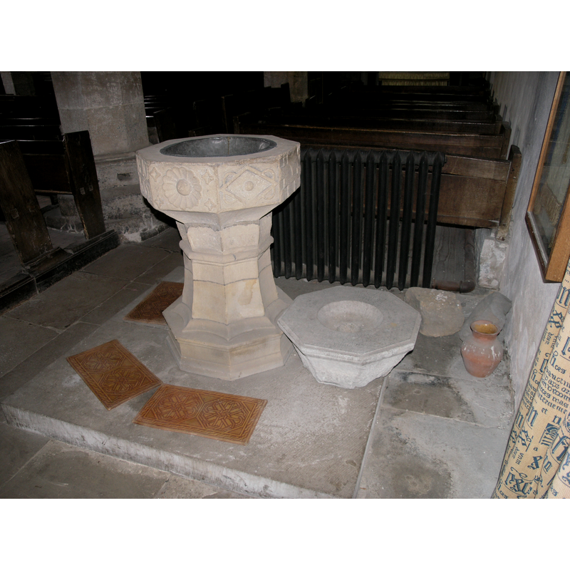 The three fonts: on the left the 16th/17th-century one in use -- to its right, a later basin, now disused -- against the right wall is a basin fragment of what may have been the original early-medieval (?) church