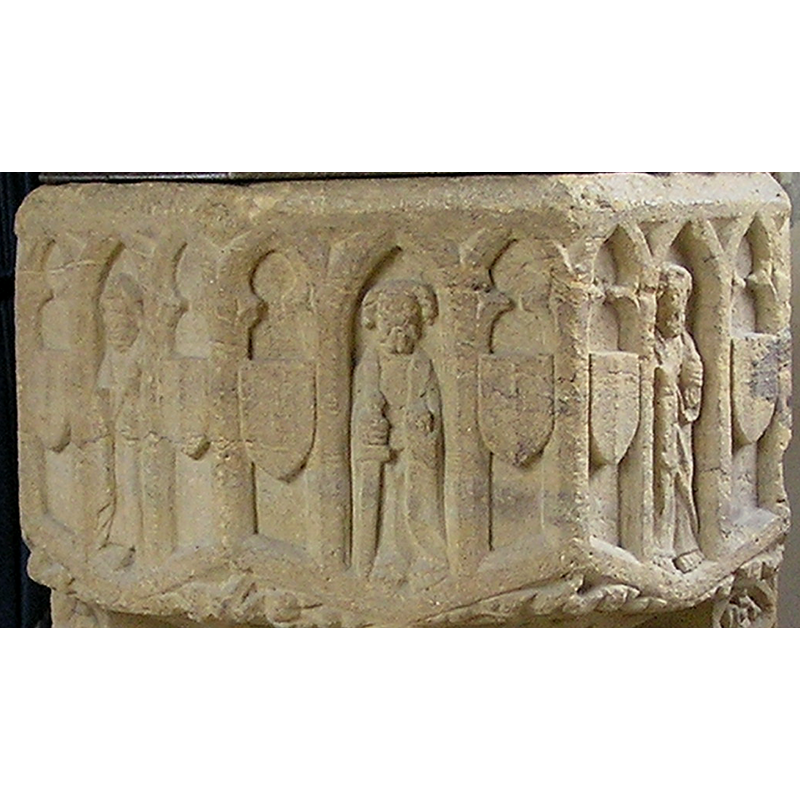 the arches which house the figures are pointed; the ones that house shields are trefoiled