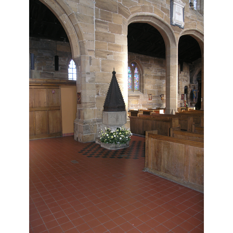 the font and cover in the west end of the nave