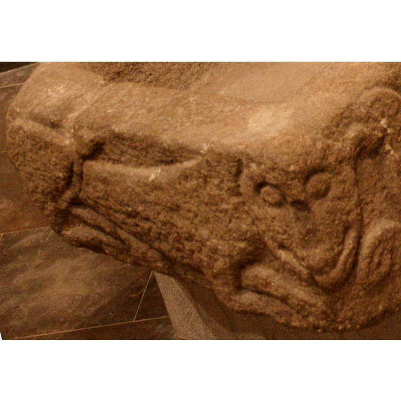 on one narrow side of the basin; shares the head with the dragon on the long side