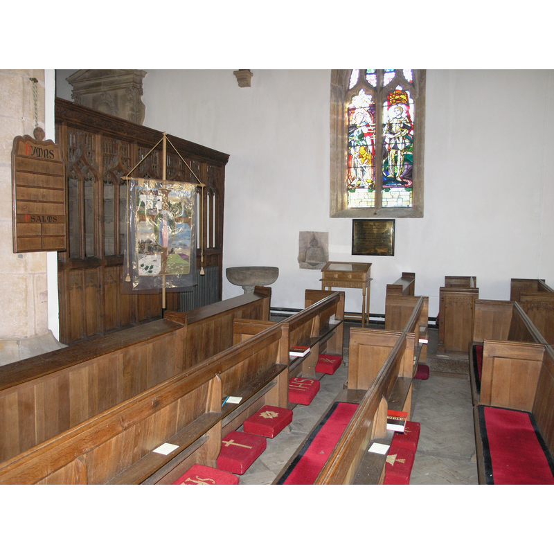 the stoup in the corner, to the left (east) of the window)