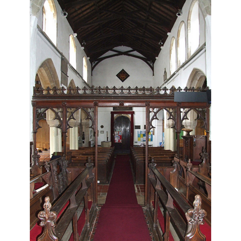 the top of the modern font is visible at the very end, behind the bank of pews on the left