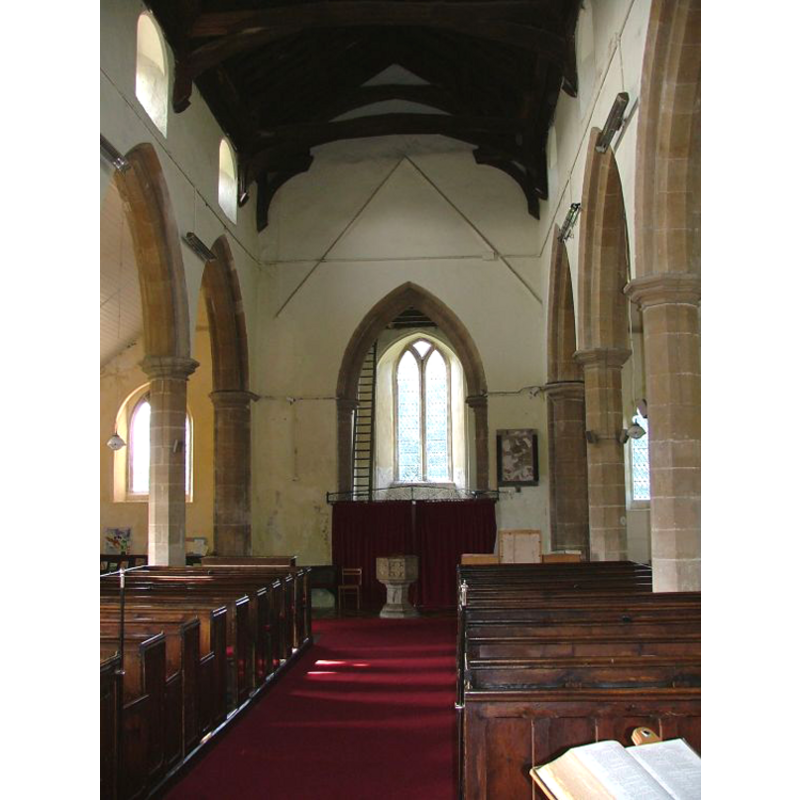 the font in the centre aisle, at the back, by the tower arch