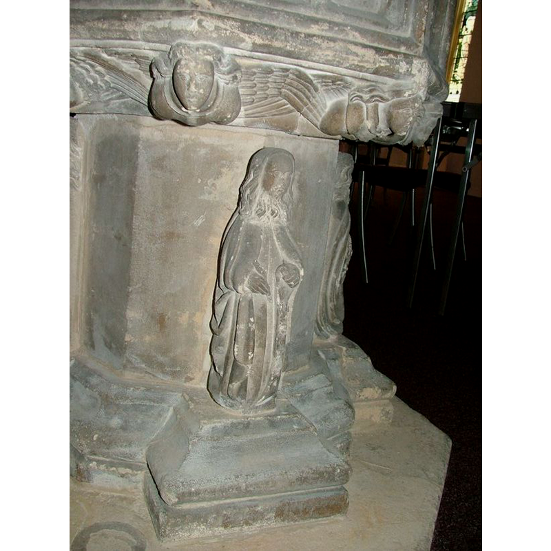 this figure carries a writing implement in the right hand