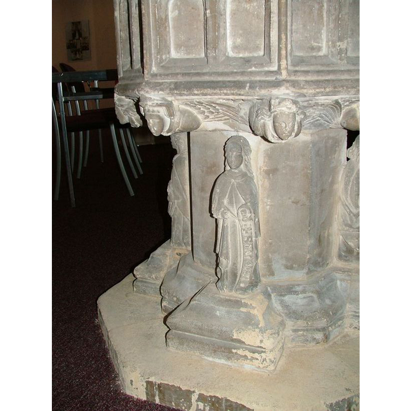 this figure carries a writing implement in the right hand