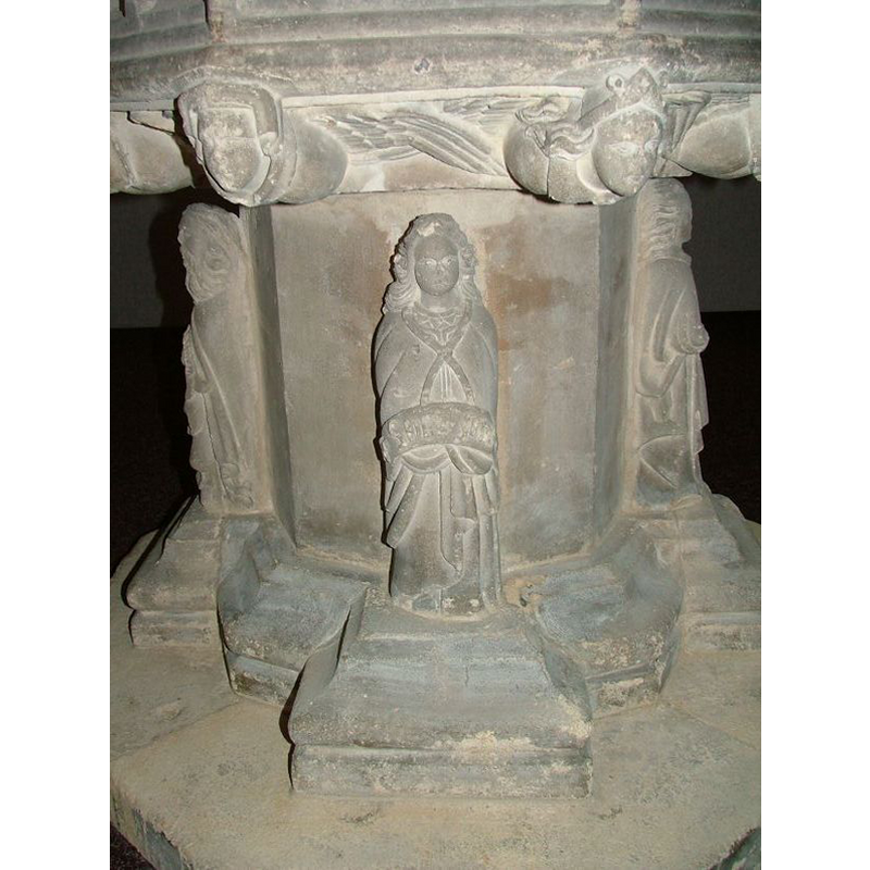 the only figure whose hands are nor visible; the scroll is wrapped around its lower body