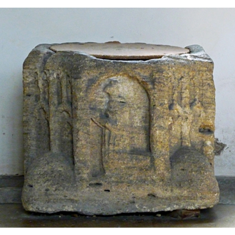 alternating with with figures -- perhaps a cleric? -- this is the disputed object: base of a cross? / well-head? / font?