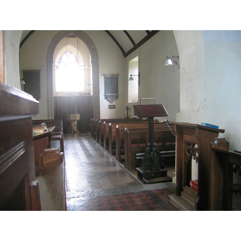 the font and cover at the west end, beneath the tower arch