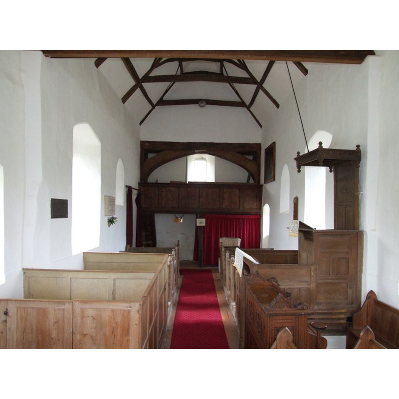 the top of the font visible at the back, right side, just in front of the red curtain