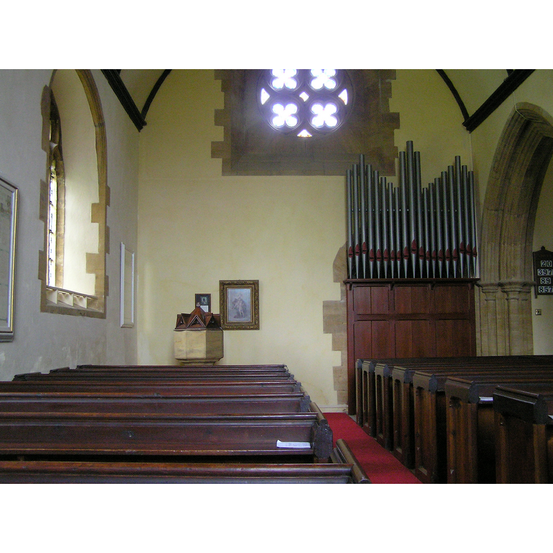 the 19th-century font and cover to the south of the organ