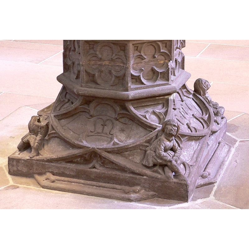 showing the intial 'M' of the date, three of the figures (one decapitated), and the tracery decoration