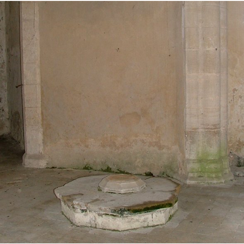 in the church interior, at the west end of the nave, on the north/right side of the west doorway, as photographed in May 2004