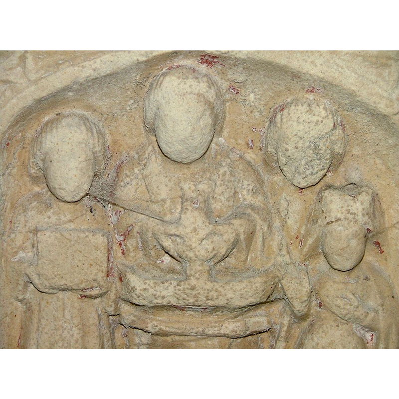 the scene of the baptism: the child being dipped in the water head first