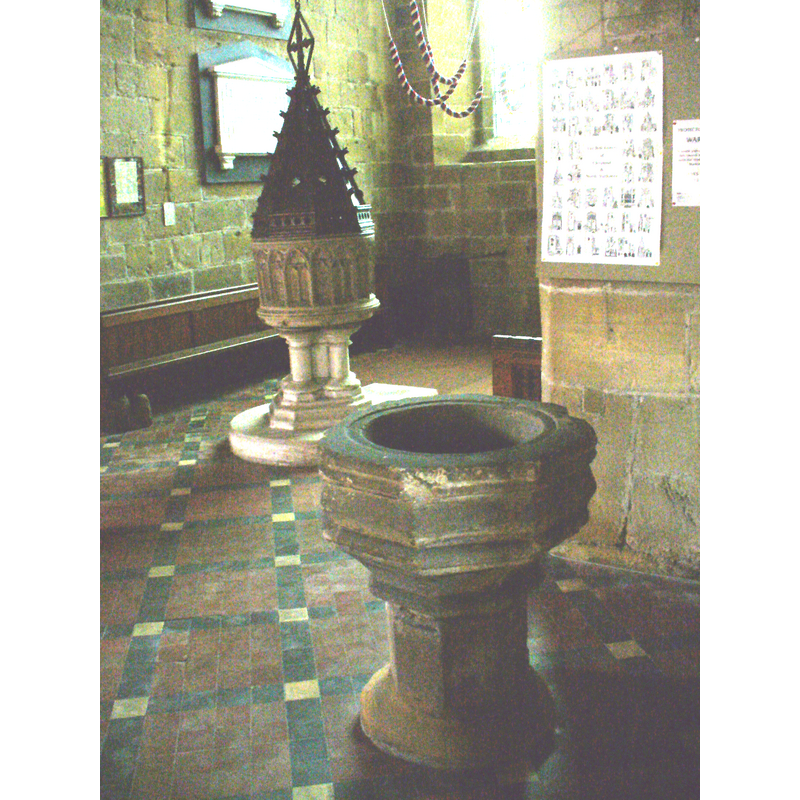 the two fonts: the 19th-century font and cover is beneath the tower [the coloured ropes are the bell-ringing ropes]; the earlier font in the foreground