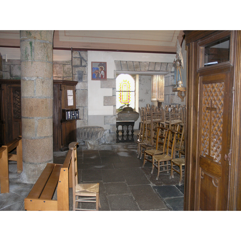 at the west end of the nave, looking south: immediately to the left/west of the door, the large stoup -- in the small recess just left/west of it, the baptismal font behind a low black railing