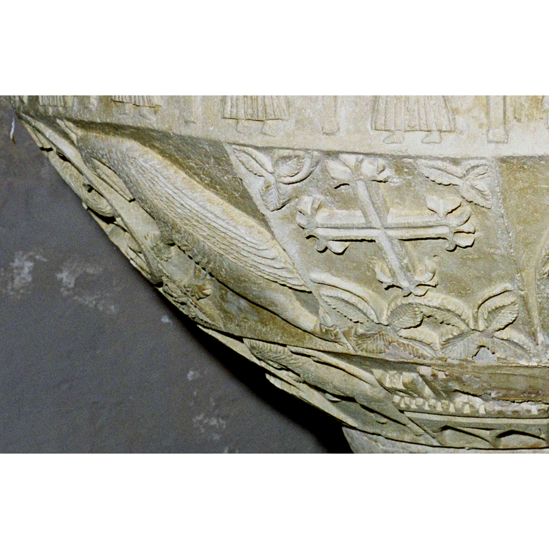 to the left of the cross; is it a peacock? an eagle?