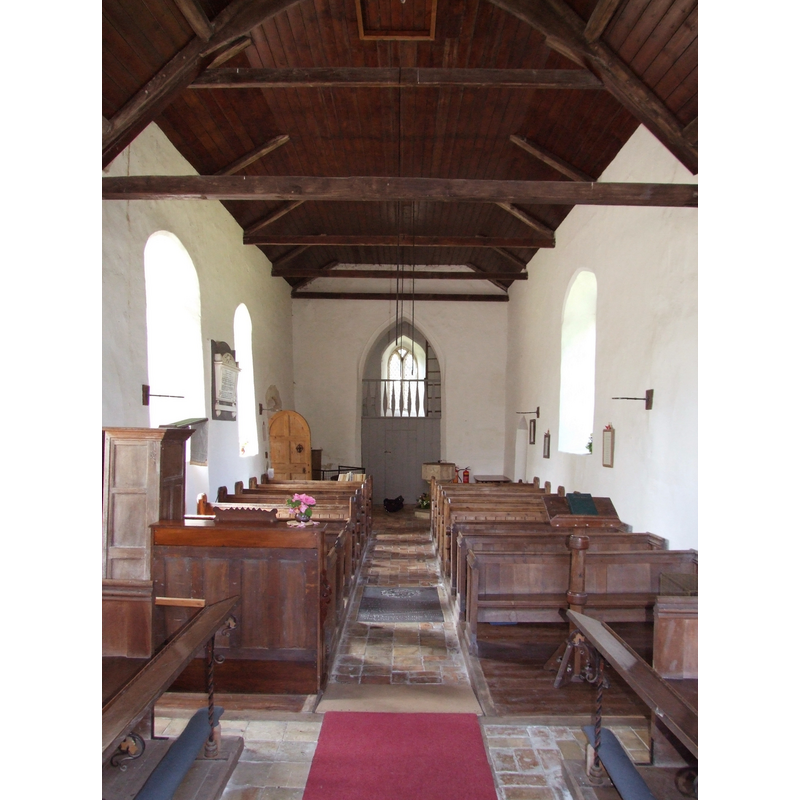 the font and cover at the west end, at the end of the right (north) bank of pews