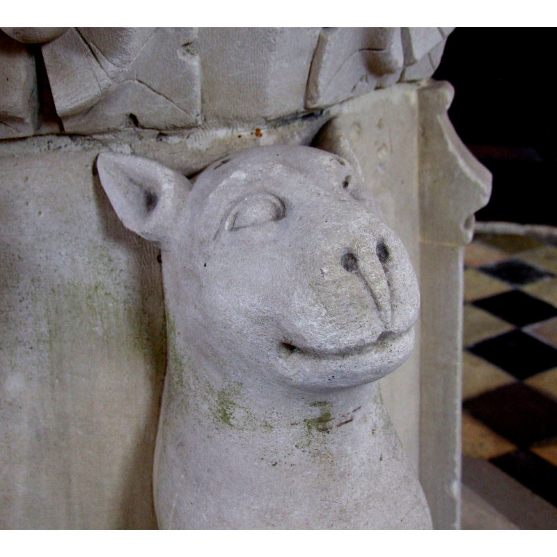 one of the four animals of the base; a lioness, rather than a leopard, most likely; a smirking feline, in any case