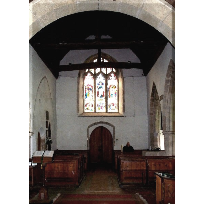 the top of the font visible on the north (right) side of the nave, among the pews