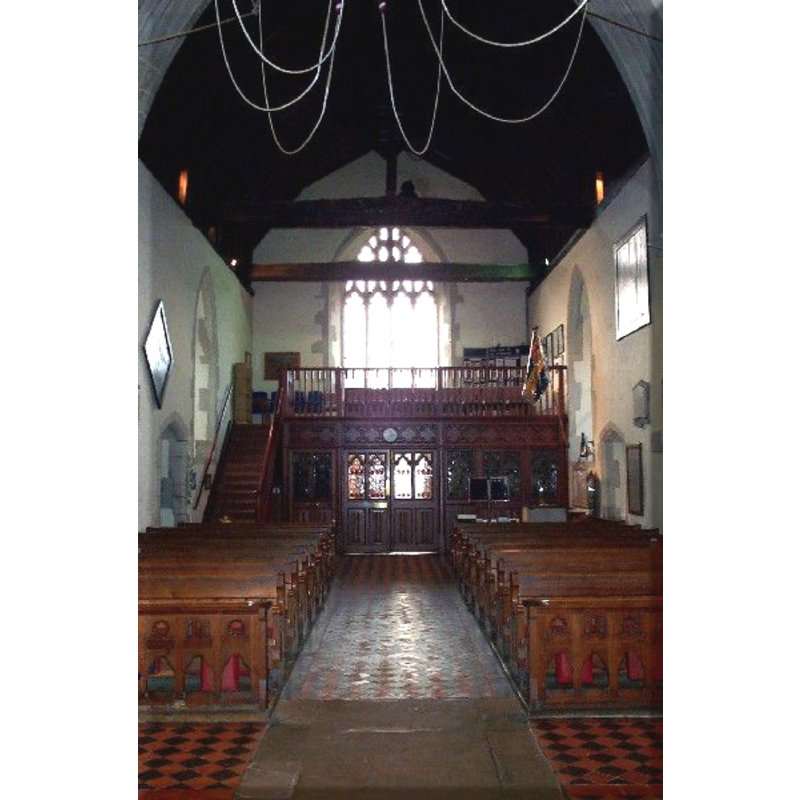 the top of the font visible at the west end, north (right) side, by the north doorway