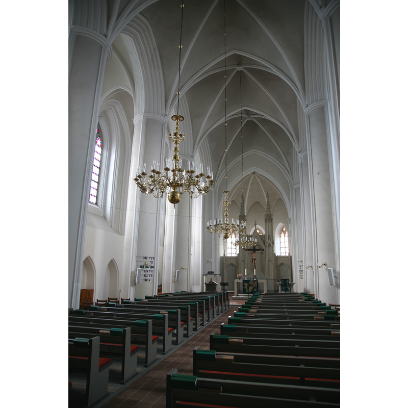 the font and cover located now at the east end, north side, to the left of the altar