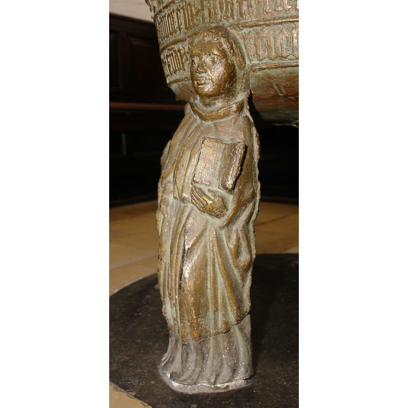 a standing cleric with an angel's head [cf. Font notes]