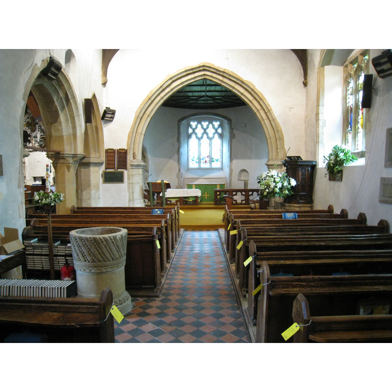 the font in the context of the nave; photograph taken 3 August 2009, during the preparations for the imminent renovation [note the labels with the recorded destination on the wooden benches]