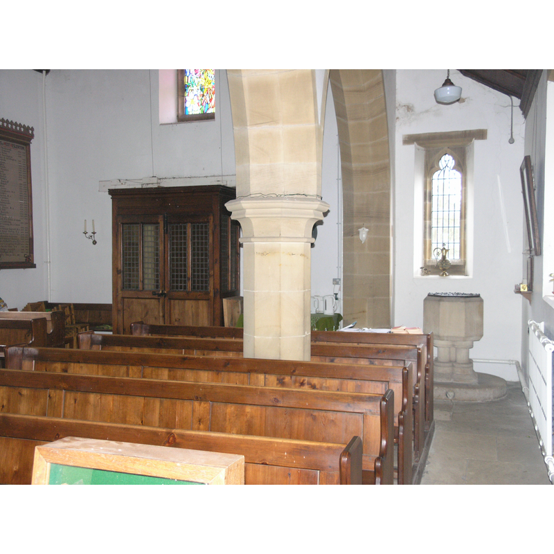the modern font at the west end of the narrow north aisle