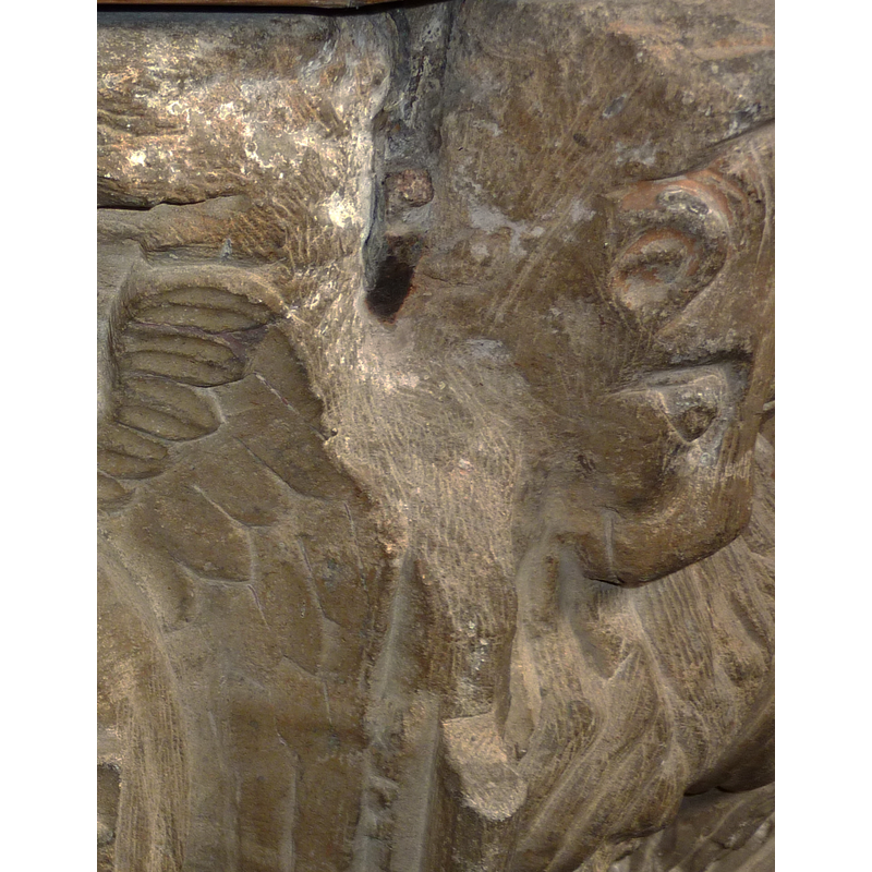 one of the damaged spots; this one probably related to the metal staple of the cover; on the basin side with the emblem of the Instruments of the Passion