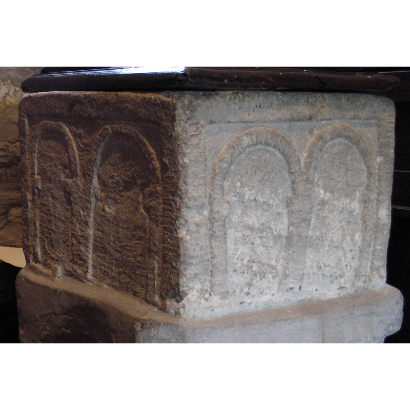 each side contains a pair of round arches framed in a thick moulded panel