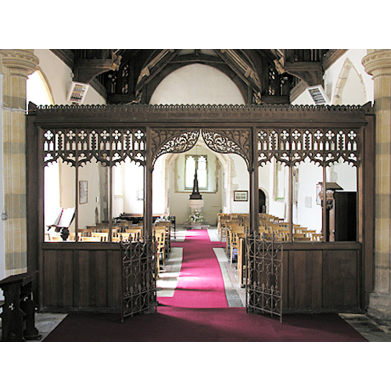 the font and cover are visible through the changel screen, at the west end of the nave