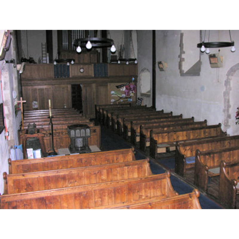the modern font located at the west end of the nave, on the south (left) side, by the south doorway
