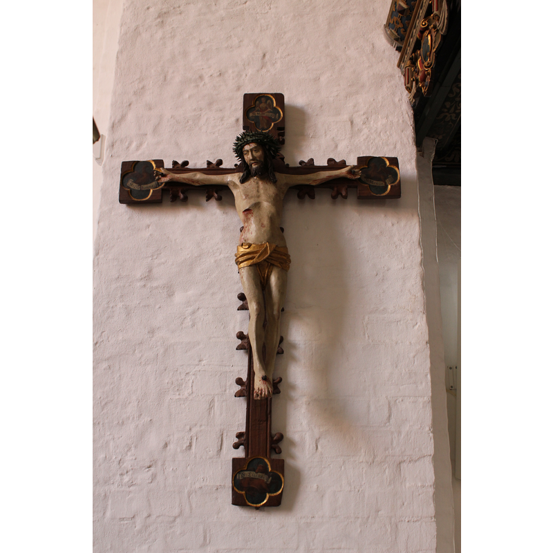 on the wall, near the font