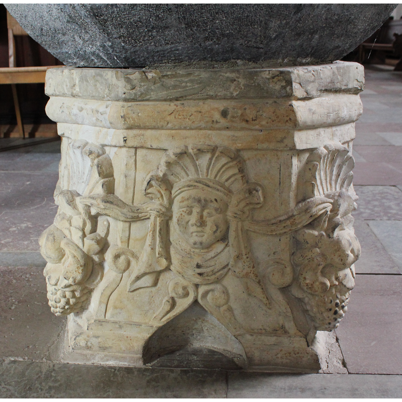 on two of the sides of the base, framed by the running garland