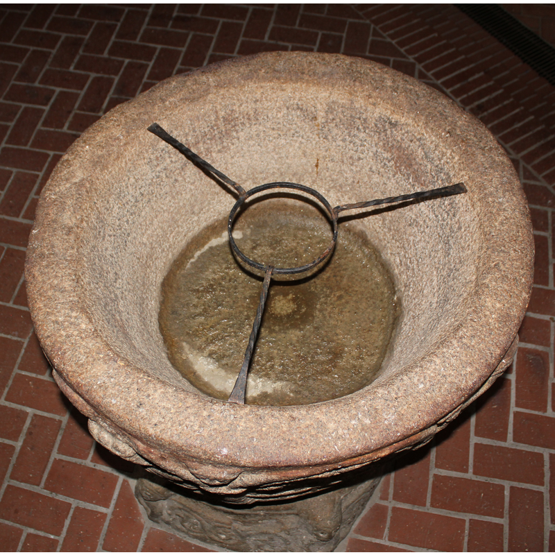 with the metal tripod that supports the brass basin used for baptisms