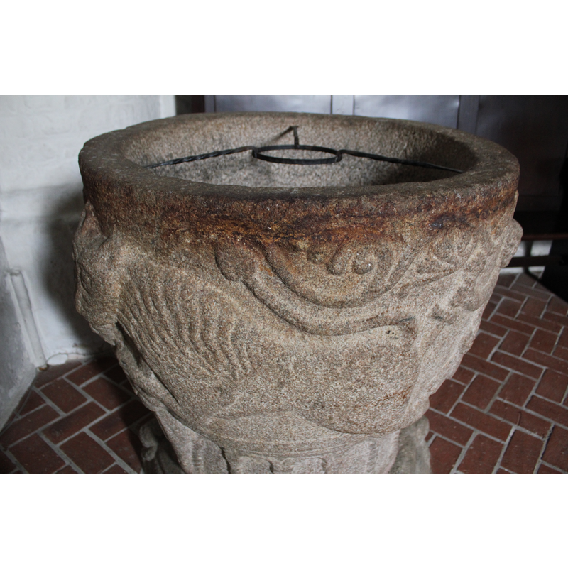 the metal tripod inside the basin supports the brass basin used for baptism