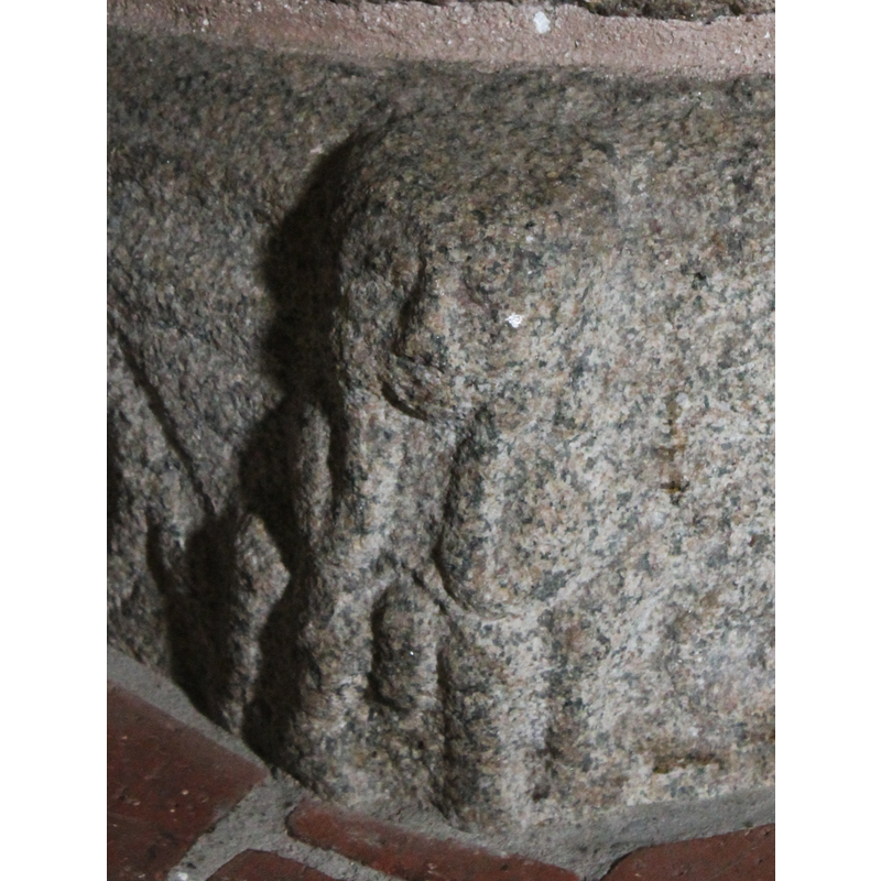 the seated figure may be more simian than human; an erect phallus appears between its legs