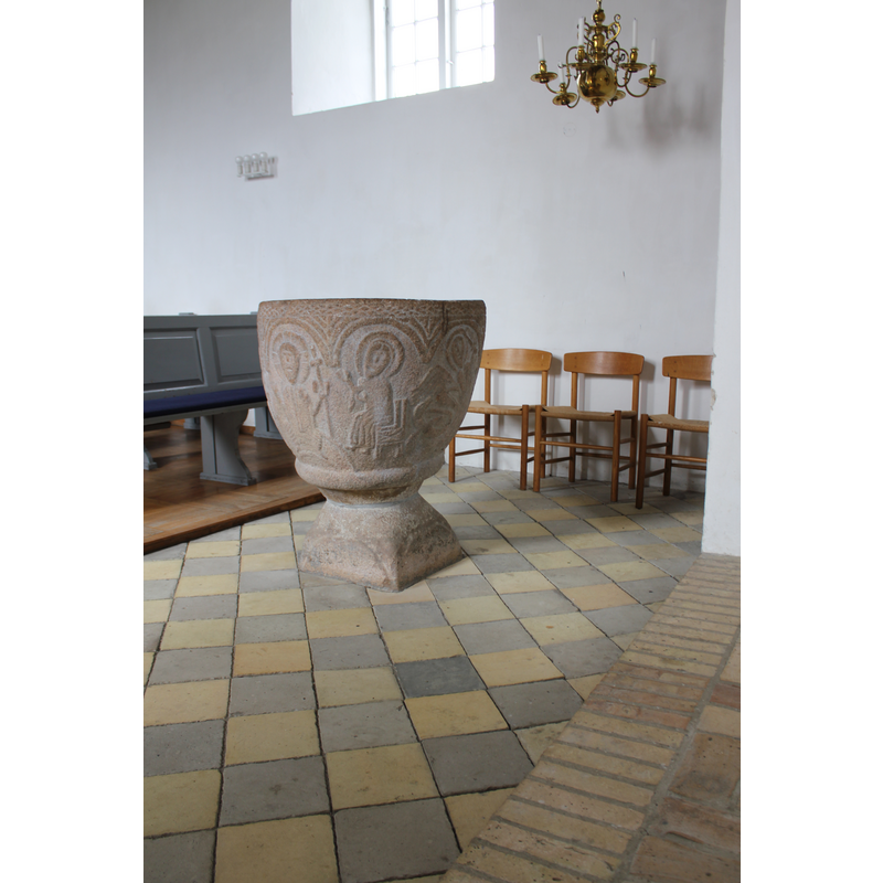 female haloed figure seated and pointing towards the enthroned Christ in the previous arch